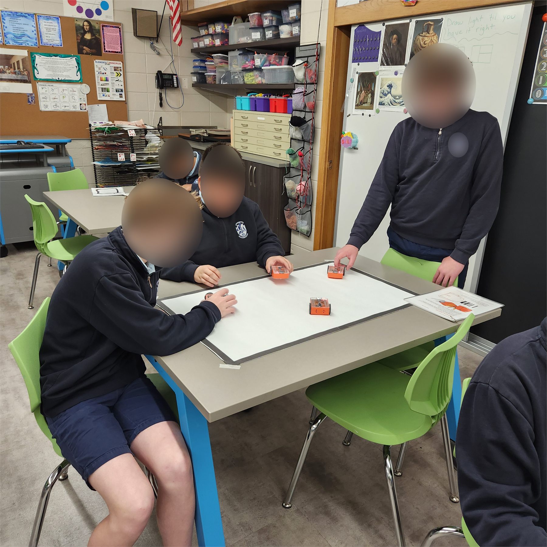 Students guiding Edison robots through a challenge