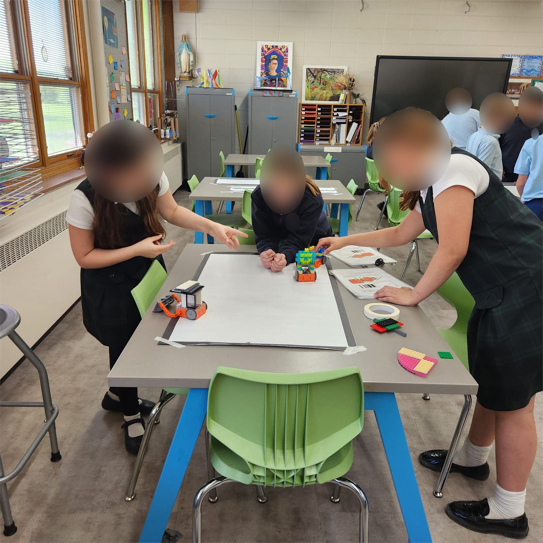 Students using Edison robots in a classroom activity